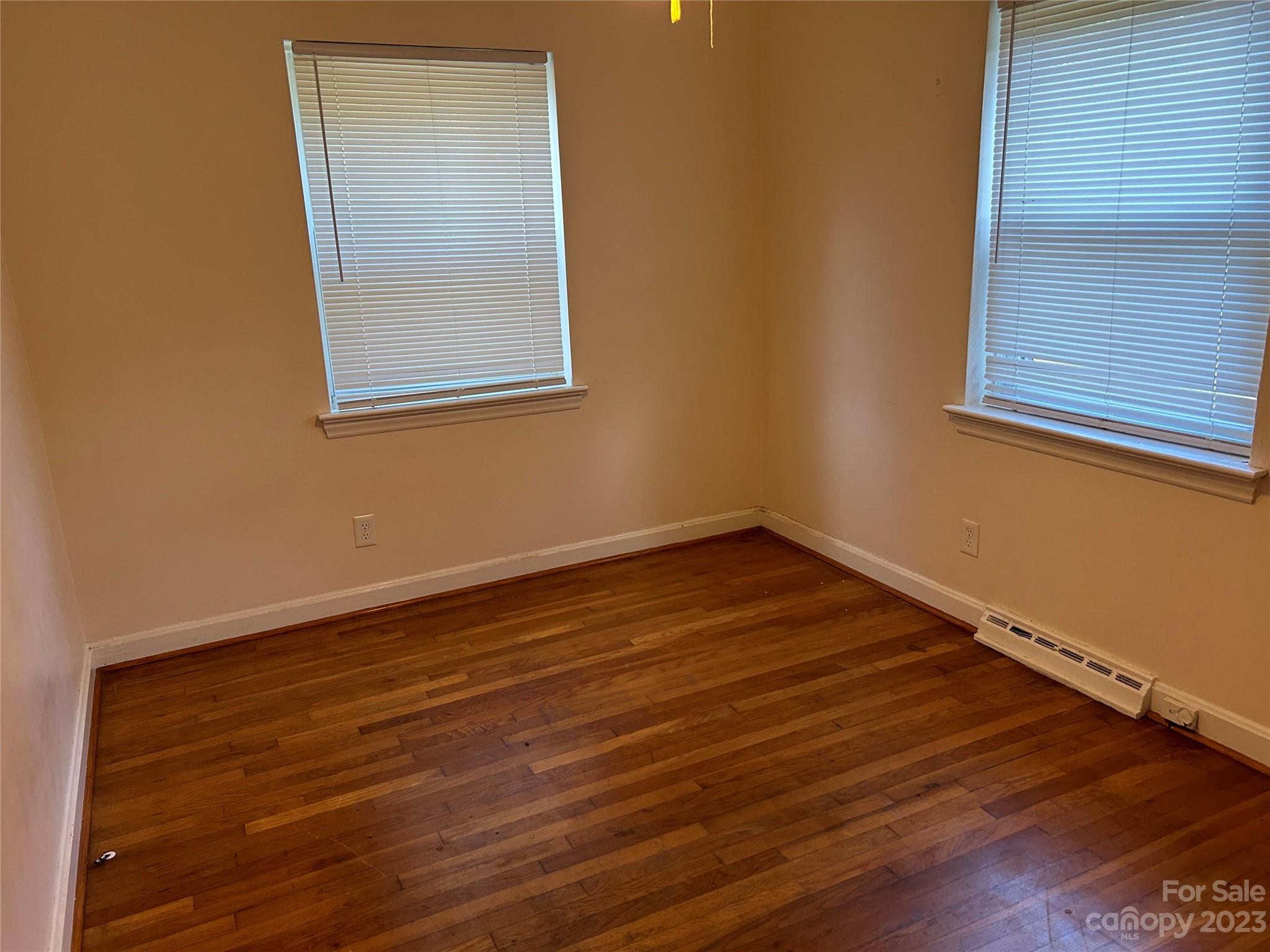 2012 Gilbert Street Charlotte, NC 28216 - Photo 9 of 13 a view of an empty room with wooden floor and a window