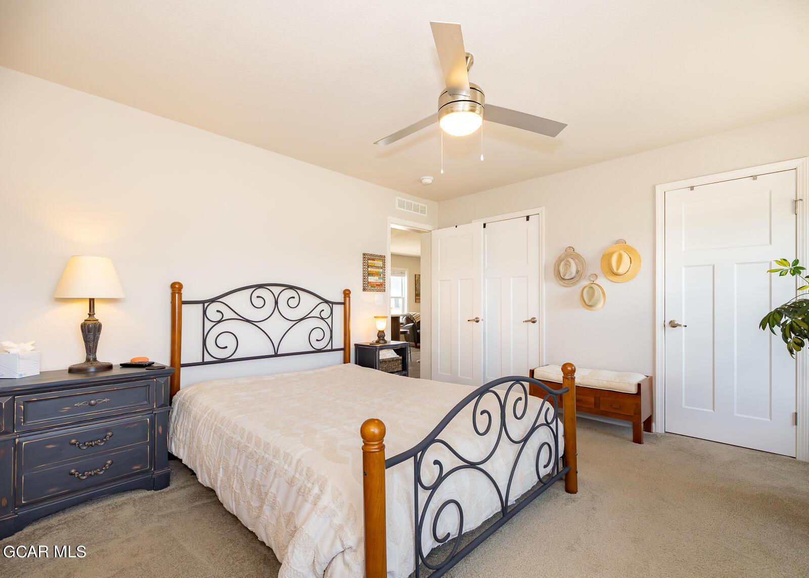 551 Summit Trail, Unit 34 Granby, CO 80446 - Photo 11 of 35 a bedroom with a bed and a lamp on the dresser