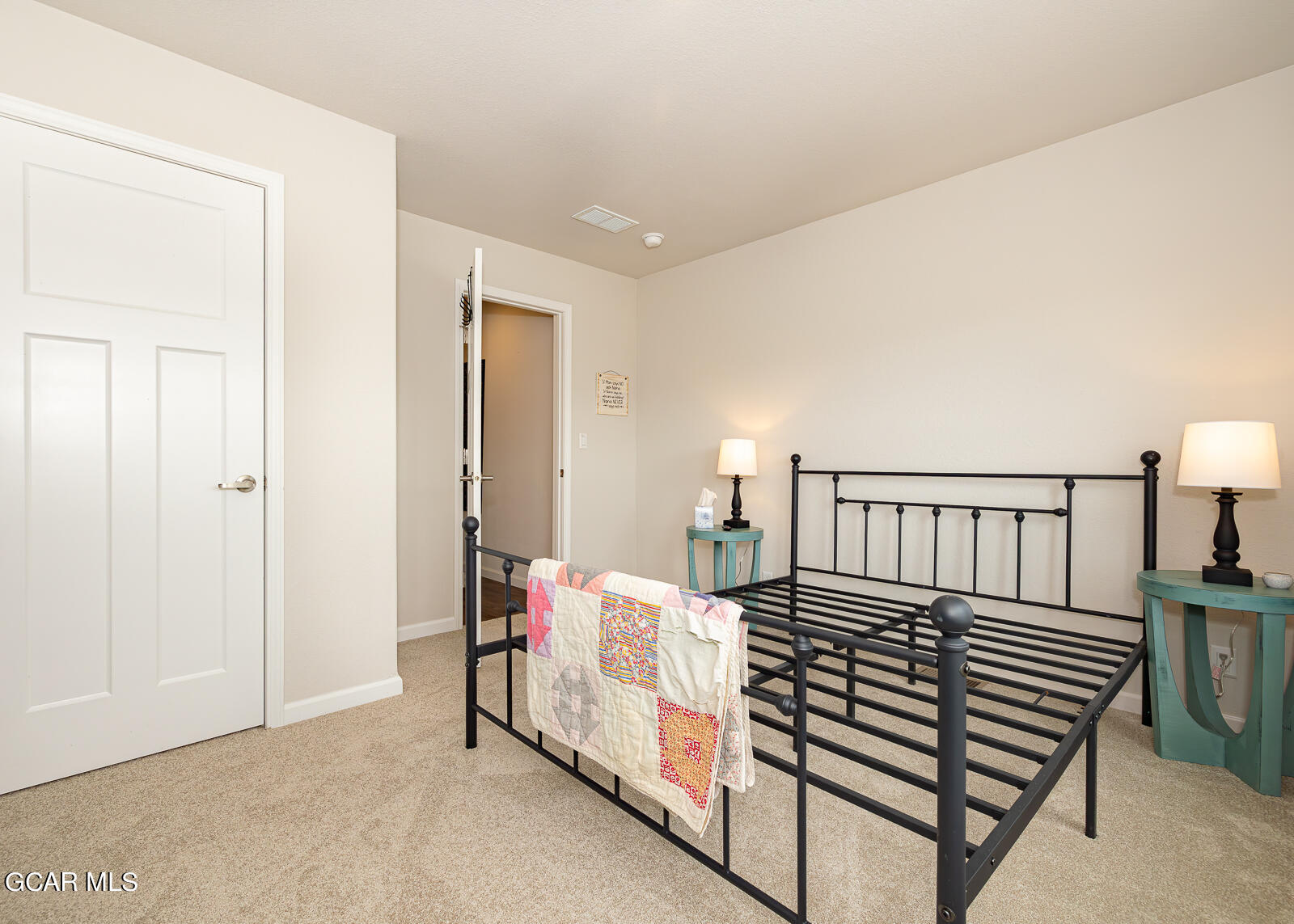 551 Summit Trail, Unit 34 Granby, CO 80446 - Photo 18 of 35 a bedroom with a bed and a lamp on dresser