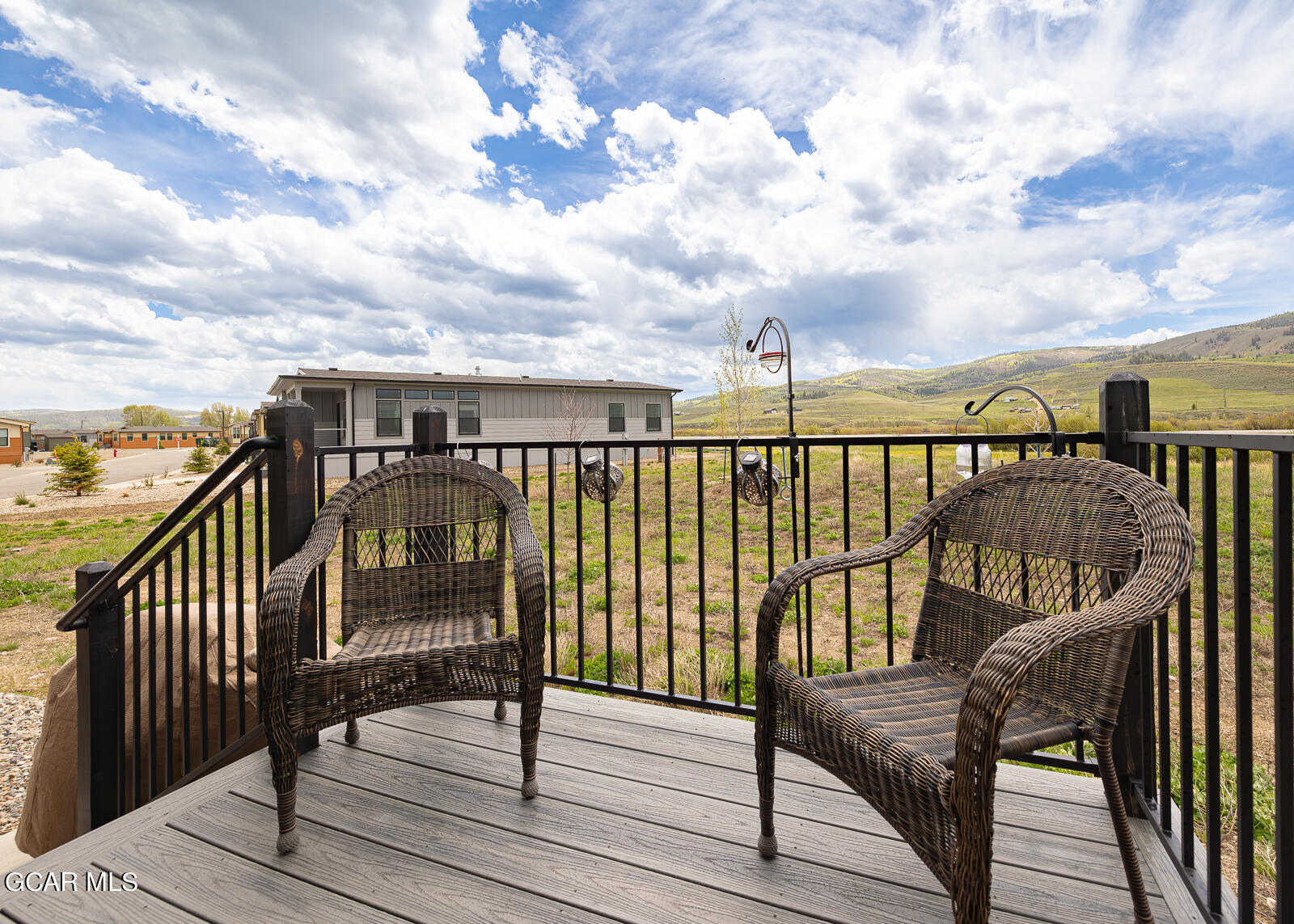 551 Summit Trail, Unit 34 Granby, CO 80446 - Photo 19 of 35 a view of roof deck with wooden floor and fence