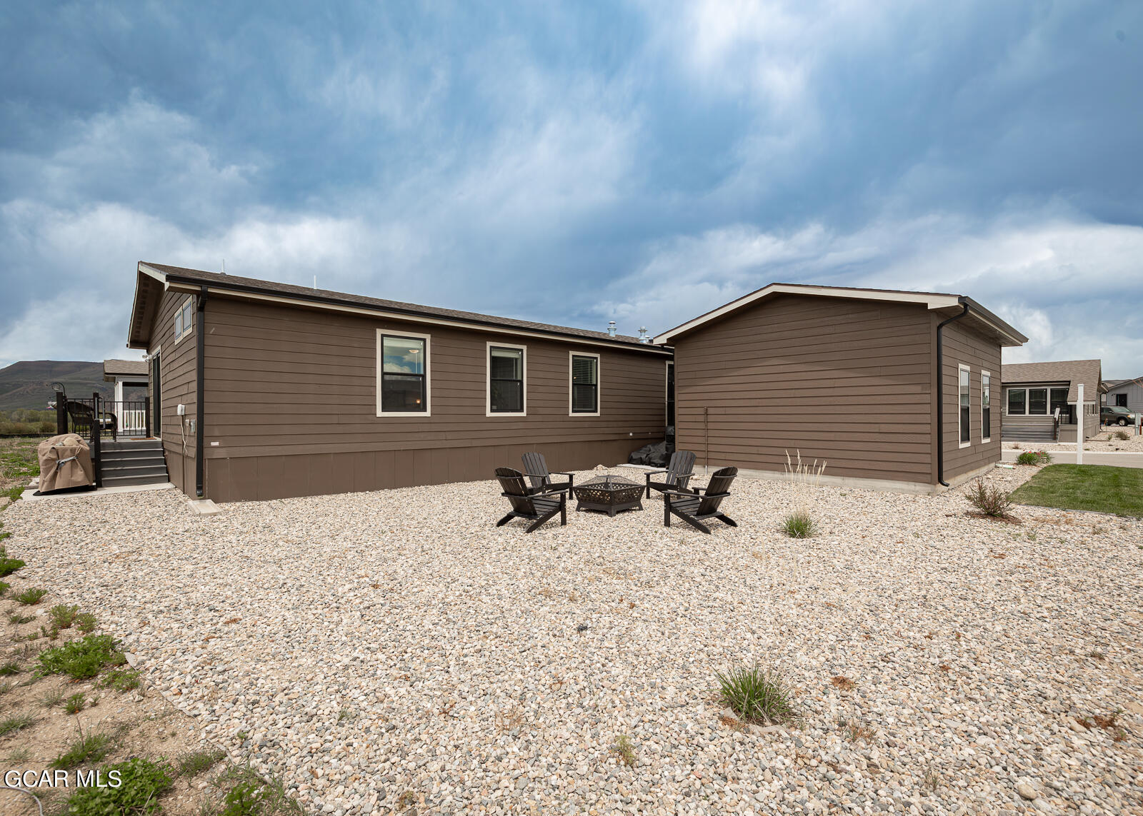 551 Summit Trail, Unit 34 Granby, CO 80446 - Photo 23 of 35 a backyard of a house with table and chairs