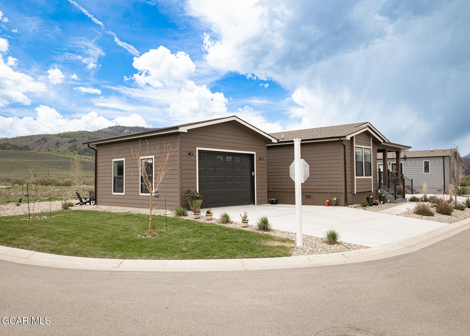 551 Summit Trail, Unit 34 Granby, CO 80446 - Photo 25 of 35 a front view of a house with a yard and garage