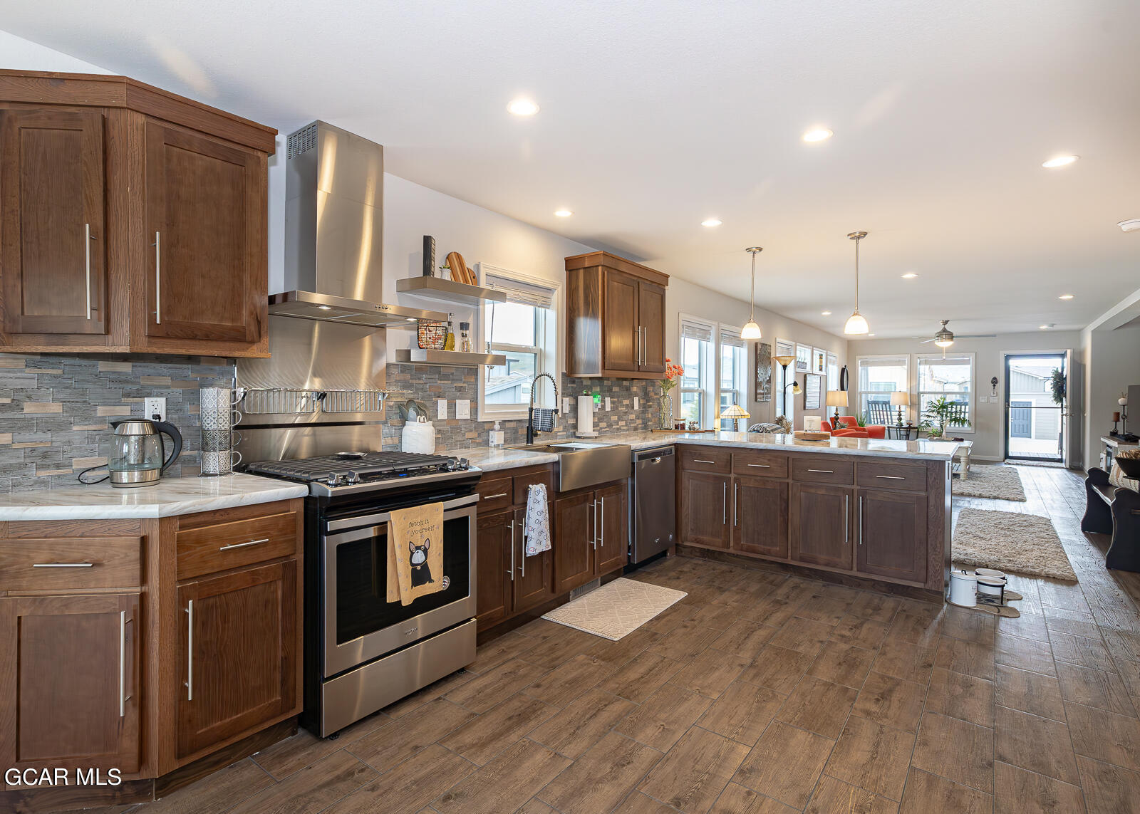 551 Summit Trail, Unit 34 Granby, CO 80446 - Photo 4 of 35 a kitchen with stainless steel appliances granite countertop wooden floors and white cabinets