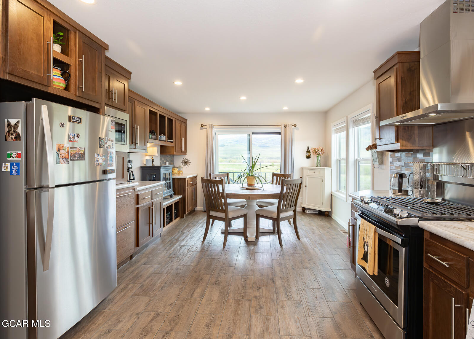 551 Summit Trail, Unit 34 Granby, CO 80446 - Photo 7 of 35 a kitchen with stainless steel appliances granite countertop a refrigerator stove microwave and cabinets