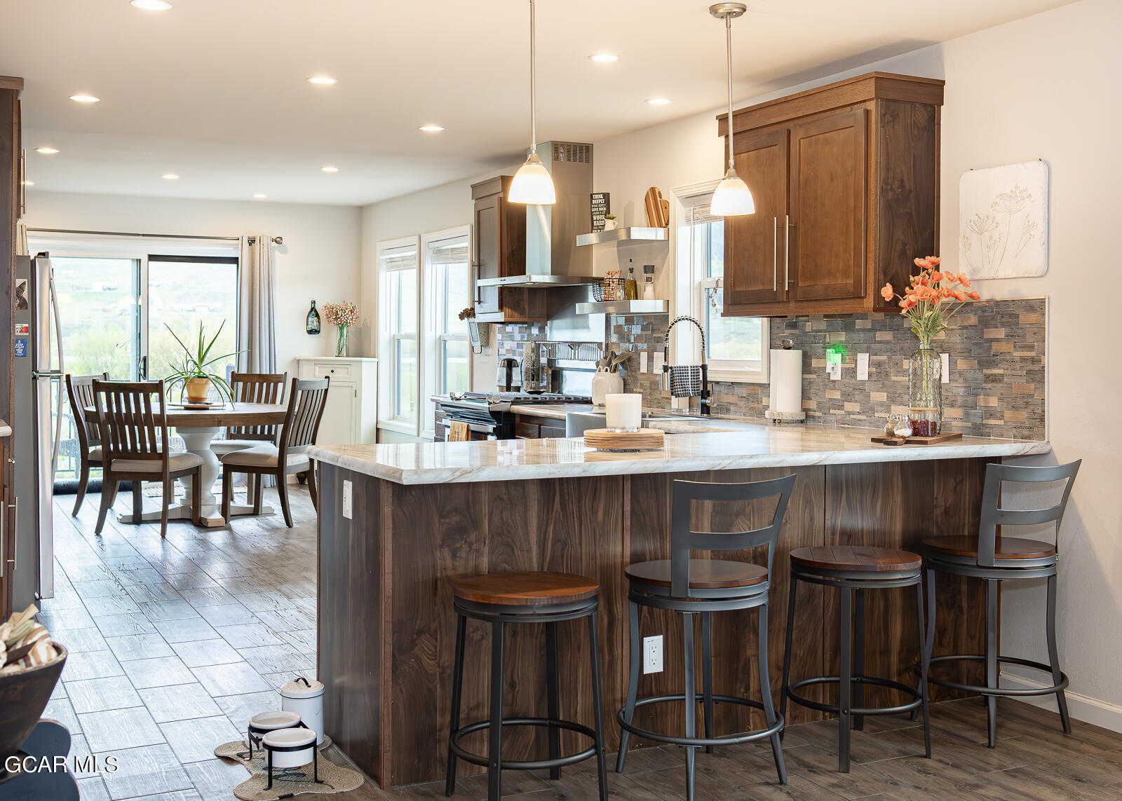 551 Summit Trail, Unit 34 Granby, CO 80446 - Photo 8 of 35 a kitchen with a dining table chairs and wooden floor