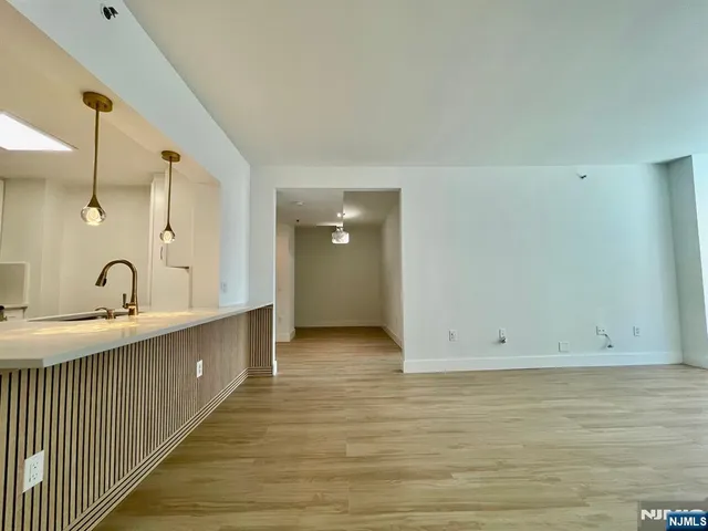 a view of a kitchen with wooden floor