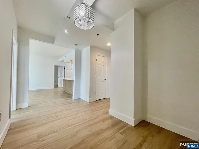 a view of an empty room and wooden floor