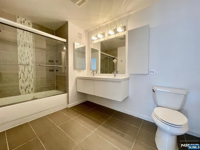 a bathroom with a toilet sink and shower