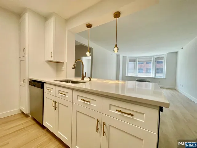 a kitchen with appliances cabinets and a table