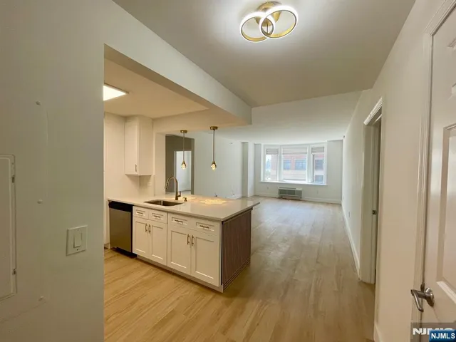 a kitchen with stainless steel appliances granite countertop a stove and a refrigerator