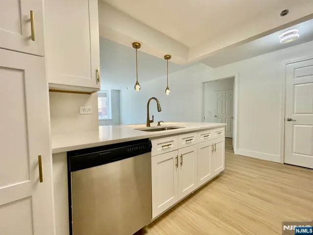 a kitchen with stainless steel appliances granite countertop a sink and cabinets