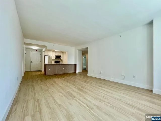a view of a room with wooden floor