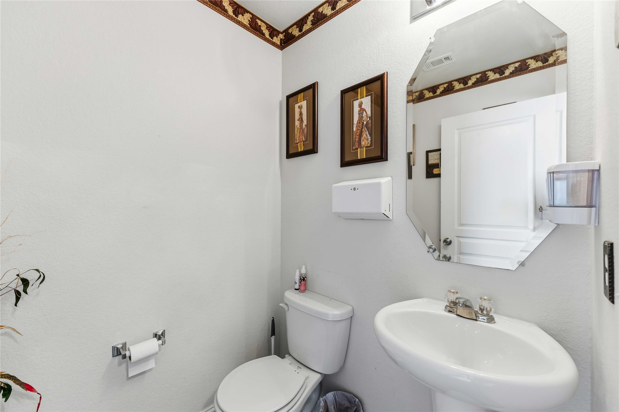 10114 Orchid Spring Lane Houston, TX 77044 - Photo 11 of 22 a bathroom with a toilet sink and mirror