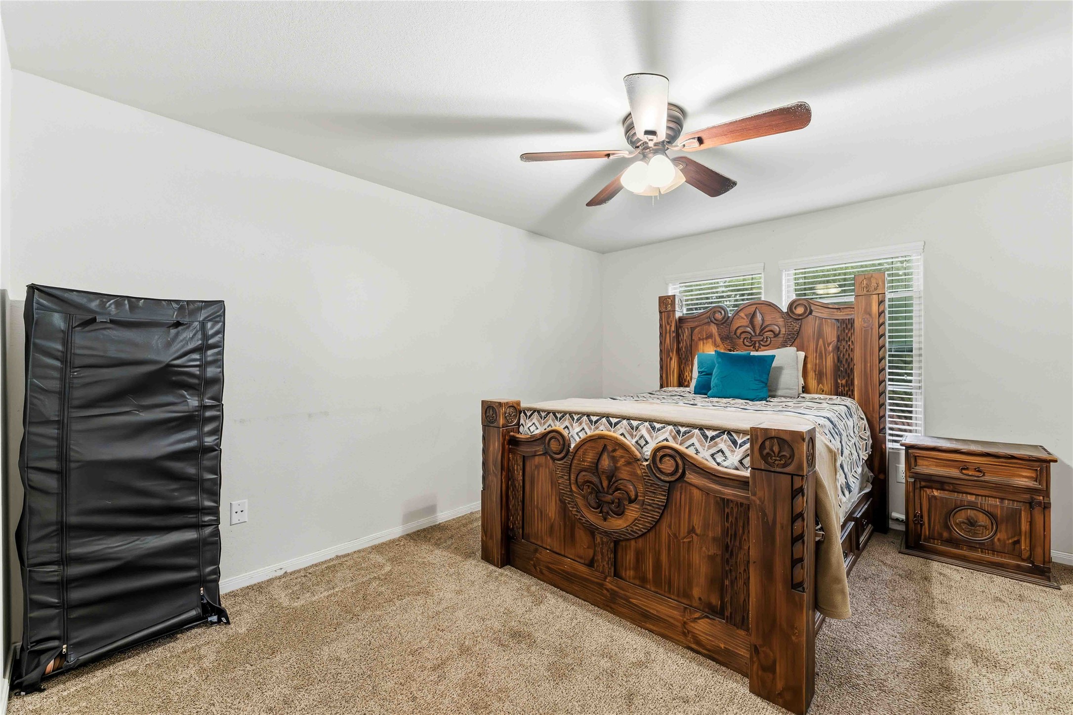10114 Orchid Spring Lane Houston, TX 77044 - Photo 13 of 22 a bedroom with a bed and a chandelier