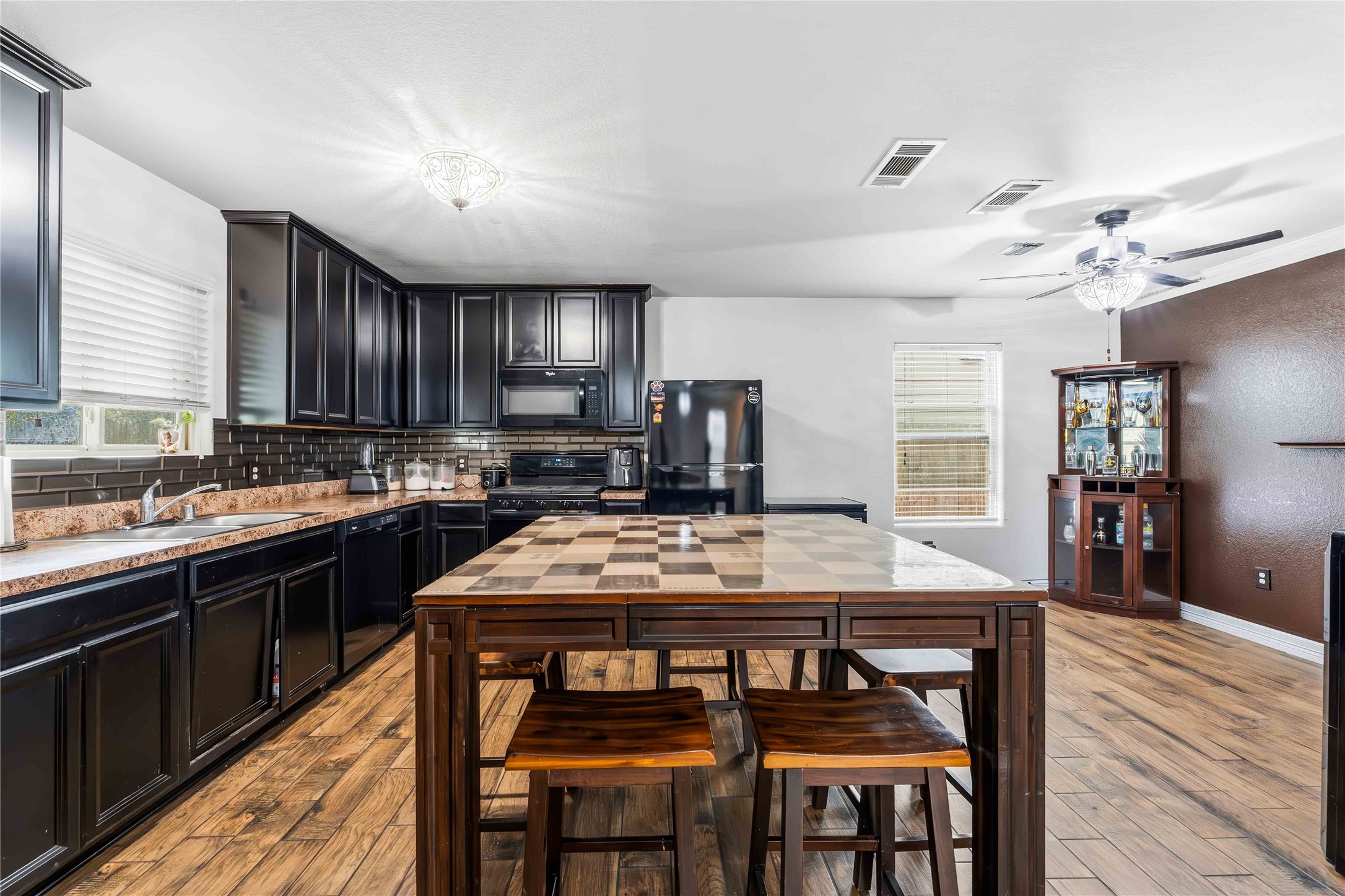 10114 Orchid Spring Lane Houston, TX 77044 - Photo 8 of 22 a kitchen with a table chairs stove and cabinets