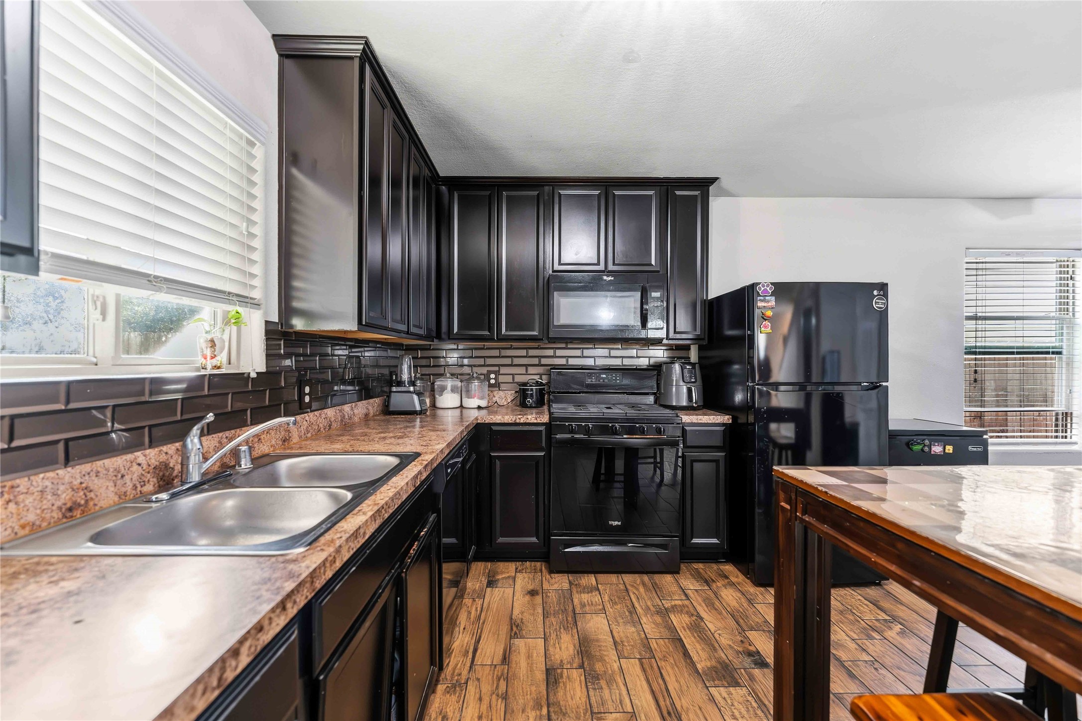 10114 Orchid Spring Lane Houston, TX 77044 - Photo 9 of 22 a kitchen with a sink stove and refrigerator