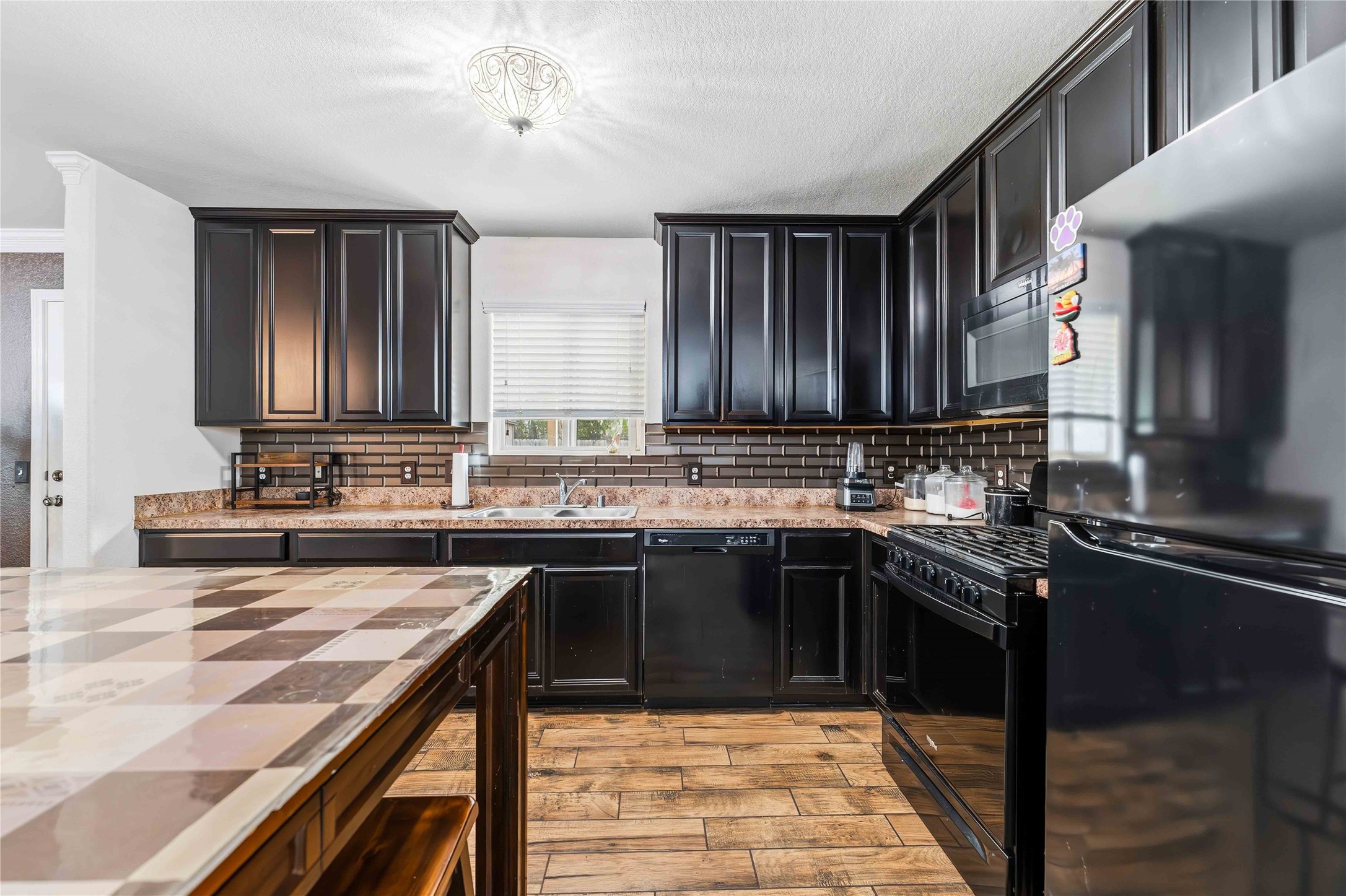 10114 Orchid Spring Lane Houston, TX 77044 - Photo 10 of 22 a kitchen with stainless steel appliances granite countertop a sink stove and refrigerator