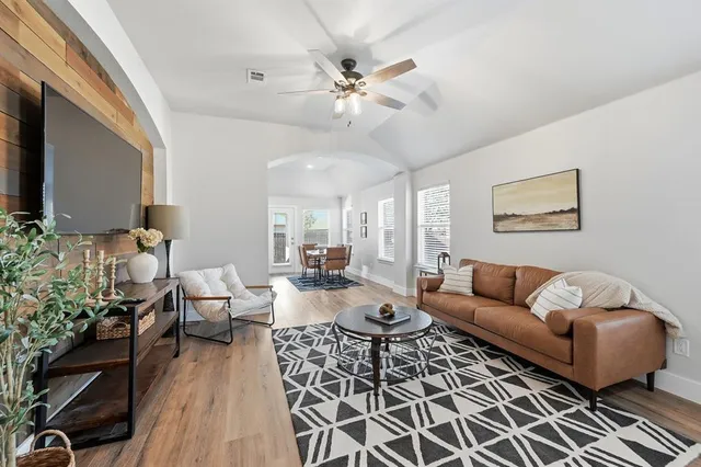 a living room with furniture and a flat screen tv