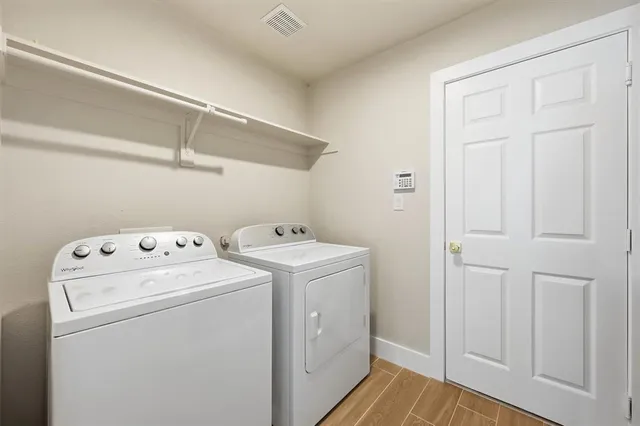 a view of storage and utility room with washer and dryer