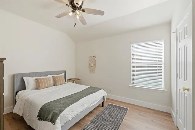 a bedroom with a bed and window