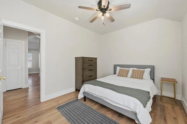 a bedroom with a bed and wooden floor