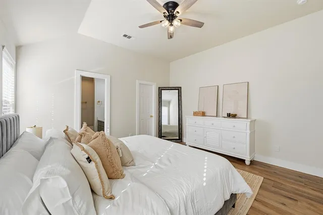 a bedroom with a bed and a chandelier