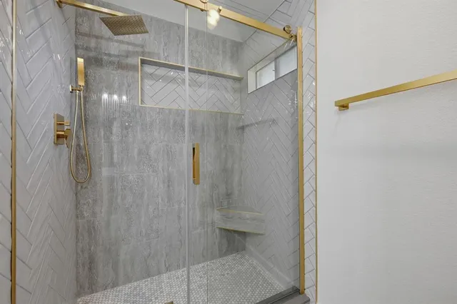 a bathroom with a glass shower door