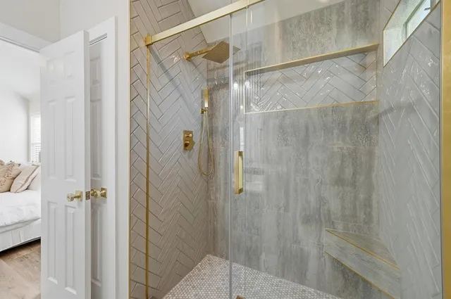 a bathroom with a glass door shower