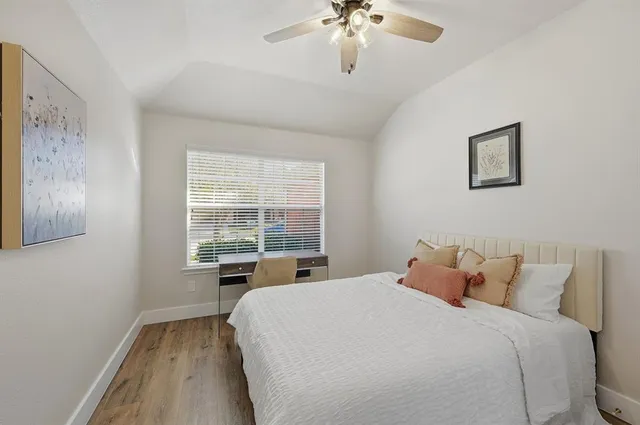 a bedroom with a large bed and a window