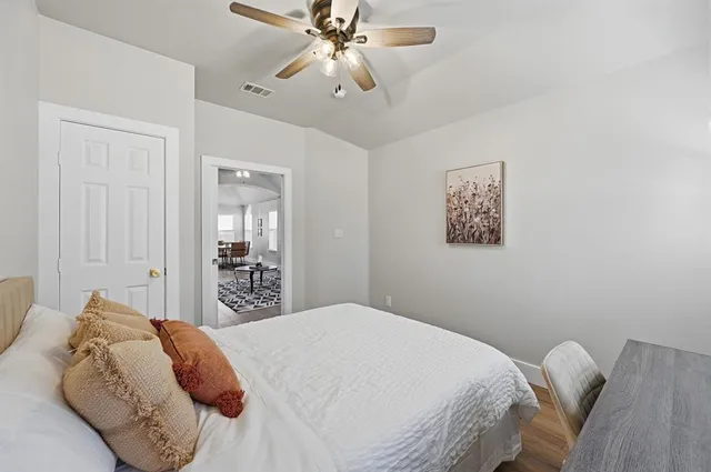 a bedroom with a bed and a chandelier