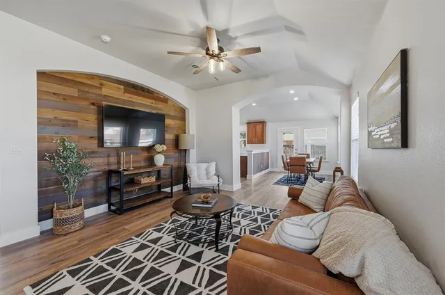 a living room with furniture and a flat screen tv