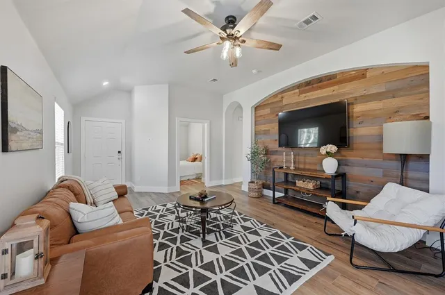 a living room with furniture and a mirror