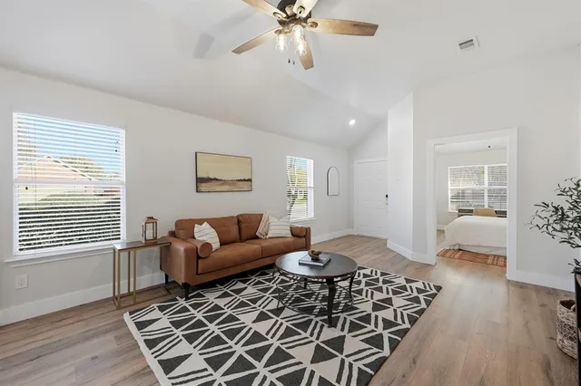 a living room with furniture and wooden floor
