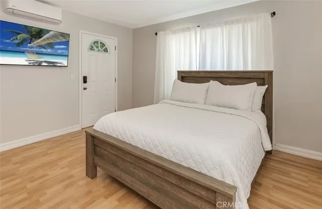 a large bed sitting in a bedroom next to a window