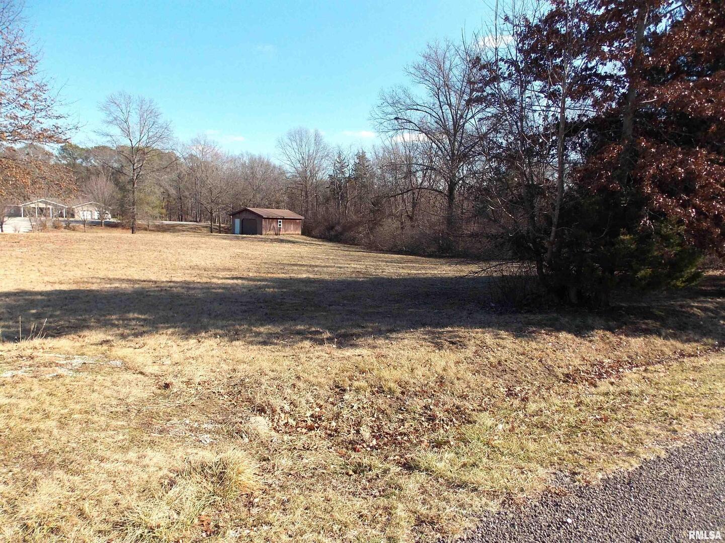 a view of a yard with wooden fence