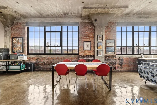 a bedroom with a bed a dresser and next to a window