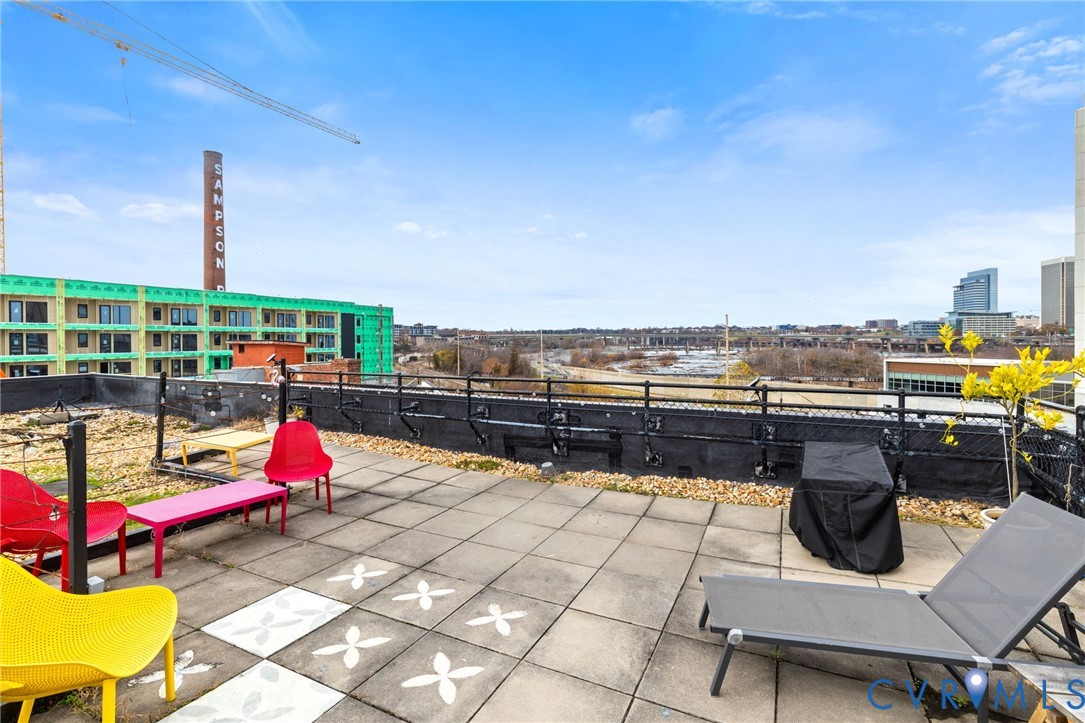 201 Hull Street, Unit U44 Richmond, VA 23224 - Photo 23 of 30 a view of roof deck with dining table and chairs