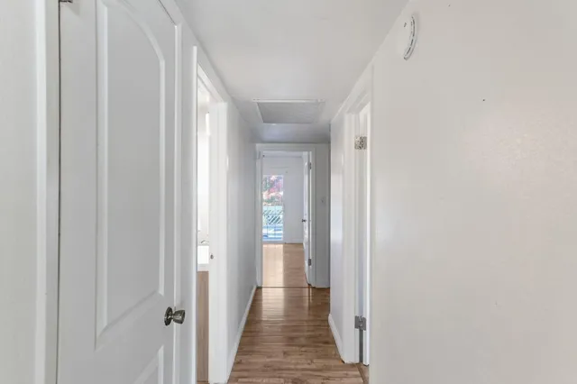 a view of a hallway with wooden floor