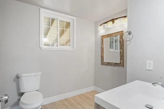 a bathroom with a toilet sink and mirror