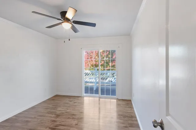 wooden floor in an empty room with a window