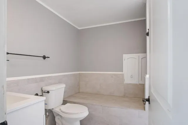 a white toilet sitting next to a bathroom sink