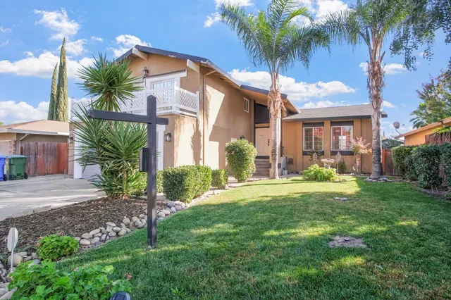 a front view of house with yard and green space
