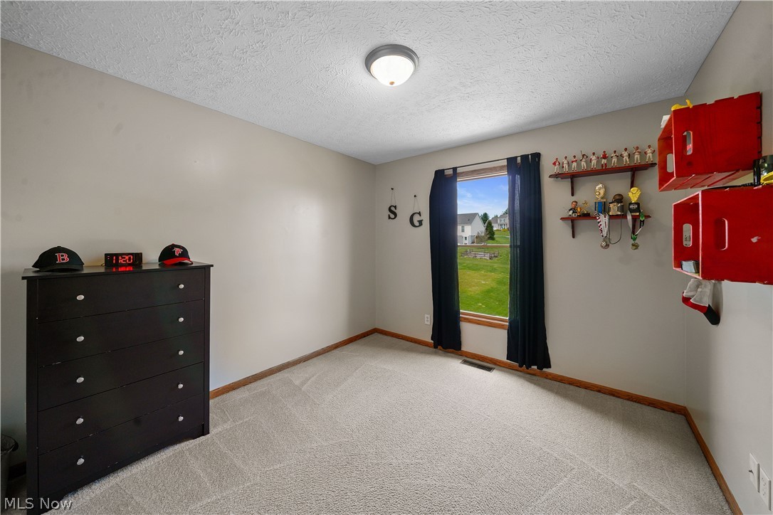 4849 Edson Road Kent, OH 44240 - Photo 28 of 50 Bedroom featuring carpet and a textured ceiling