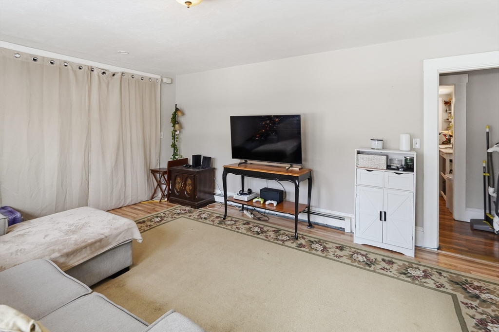 72 Main Street Pepperell, MA 01463 - Photo 20 of 26 a bedroom with a bed and a flat screen tv