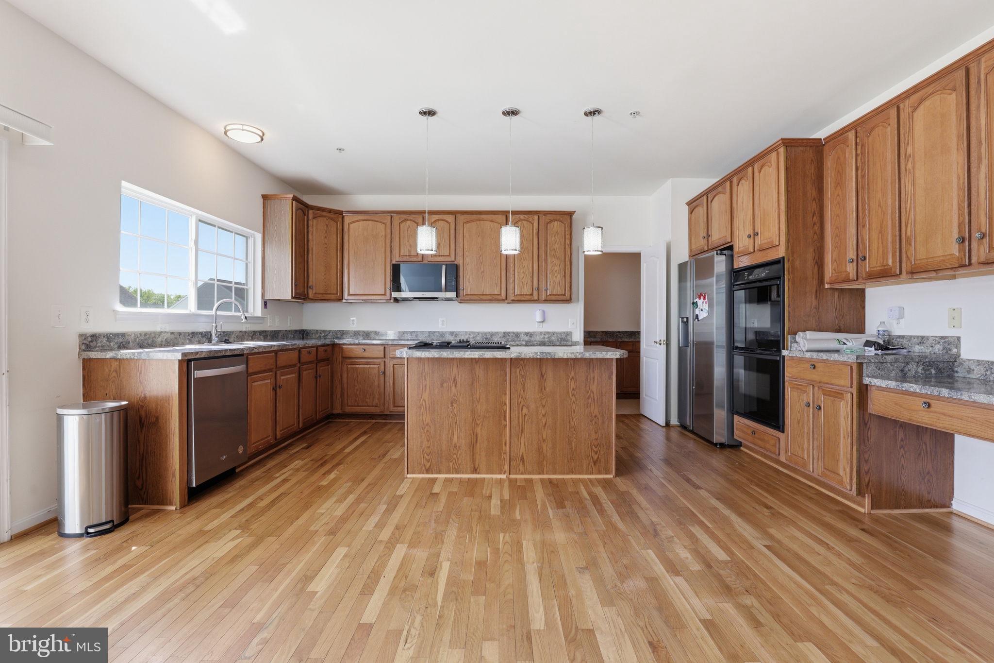 10105 Elgin Circle Bowie, MD 20721 - Photo 12 of 32 a kitchen with stainless steel appliances granite countertop a stove top oven a sink dishwasher and a refrigerator