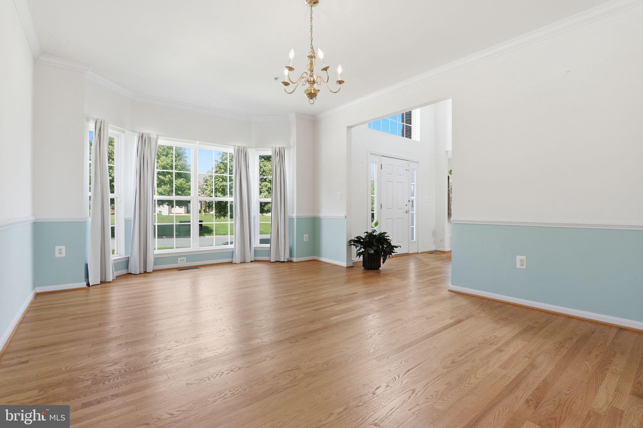 10105 Elgin Circle Bowie, MD 20721 - Photo 14 of 32 an empty room with wooden floor and windows