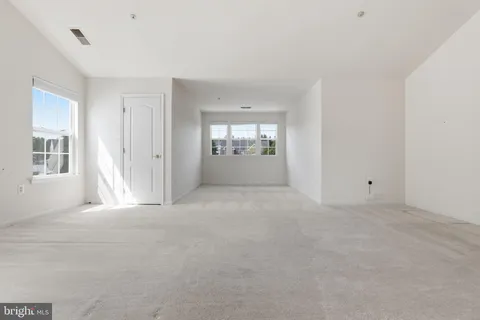 a view of an empty room with windows