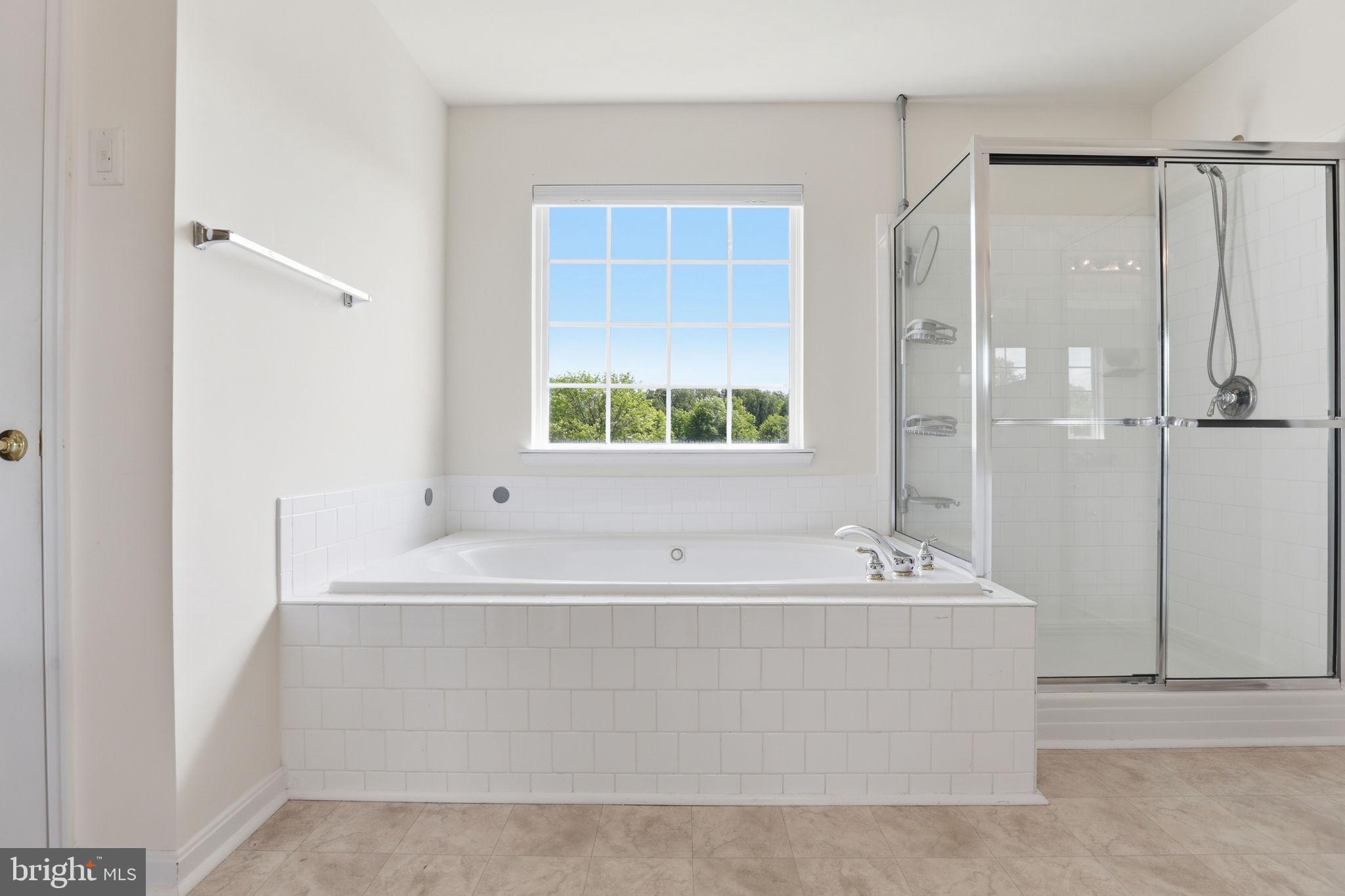 10105 Elgin Circle Bowie, MD 20721 - Photo 20 of 32 a bathroom with a bathtub and a shower