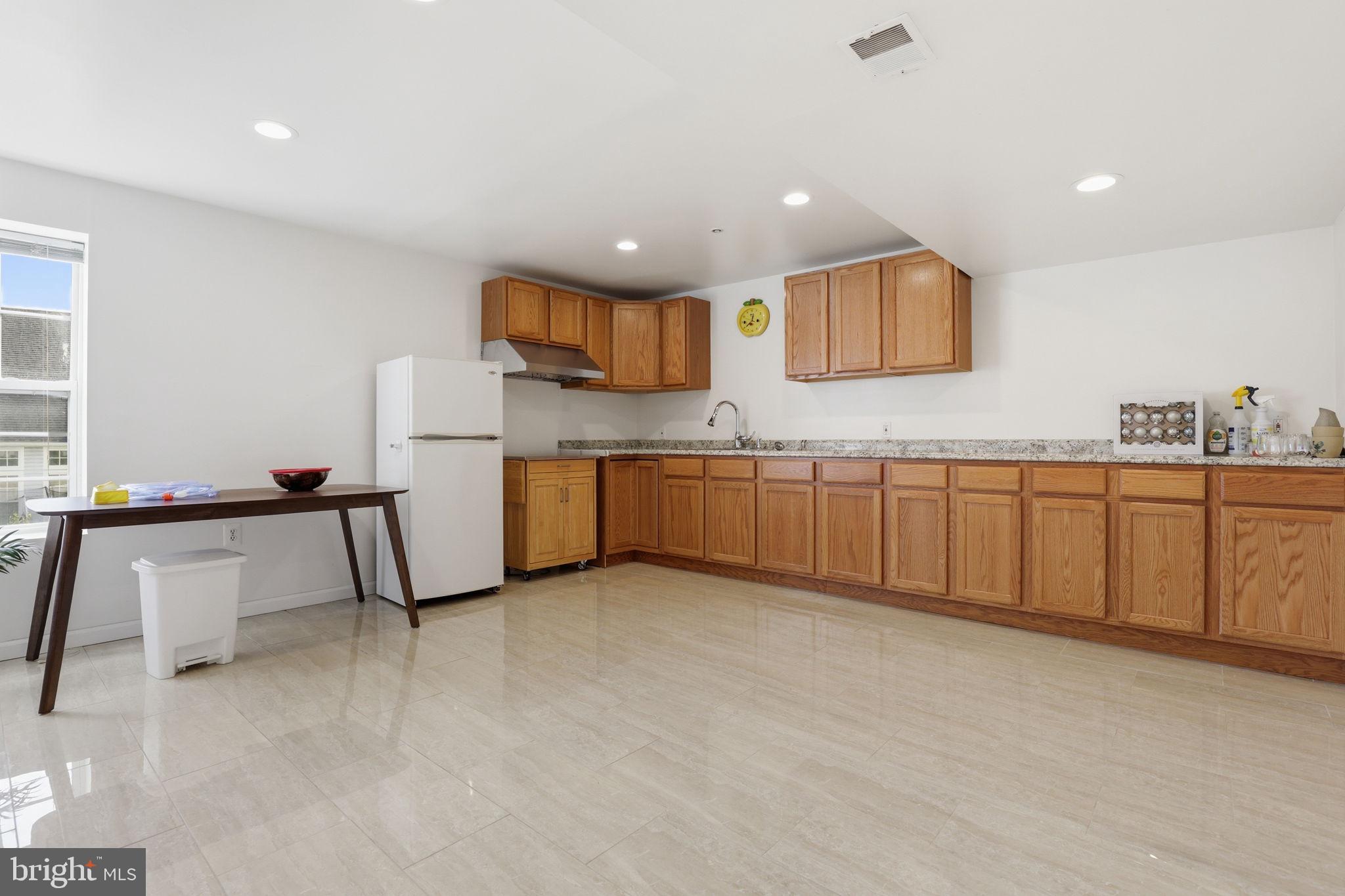 10105 Elgin Circle Bowie, MD 20721 - Photo 29 of 32 a kitchen with stainless steel appliances granite countertop a sink and a refrigerator