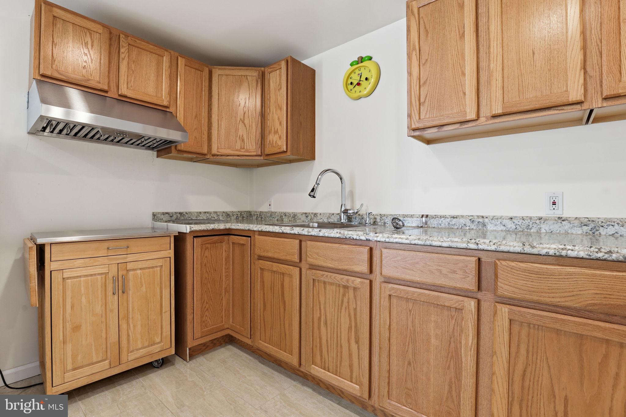 10105 Elgin Circle Bowie, MD 20721 - Photo 30 of 32 a kitchen with granite countertop stainless steel appliances white cabinets sink and a granite counter top
